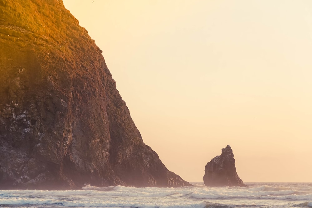 brown rock formation on sea during daytime