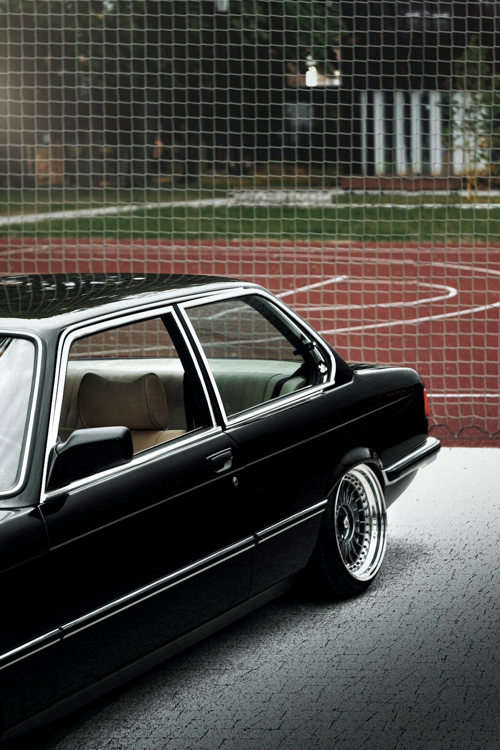 black sedan on red brick floor