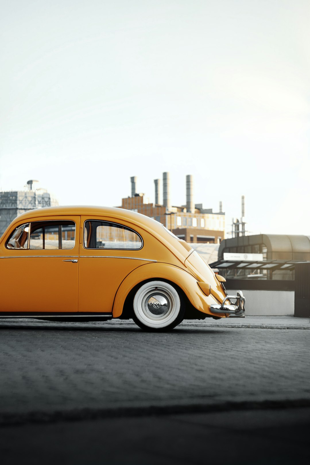 yellow volkswagen beetle parked on the street during daytime