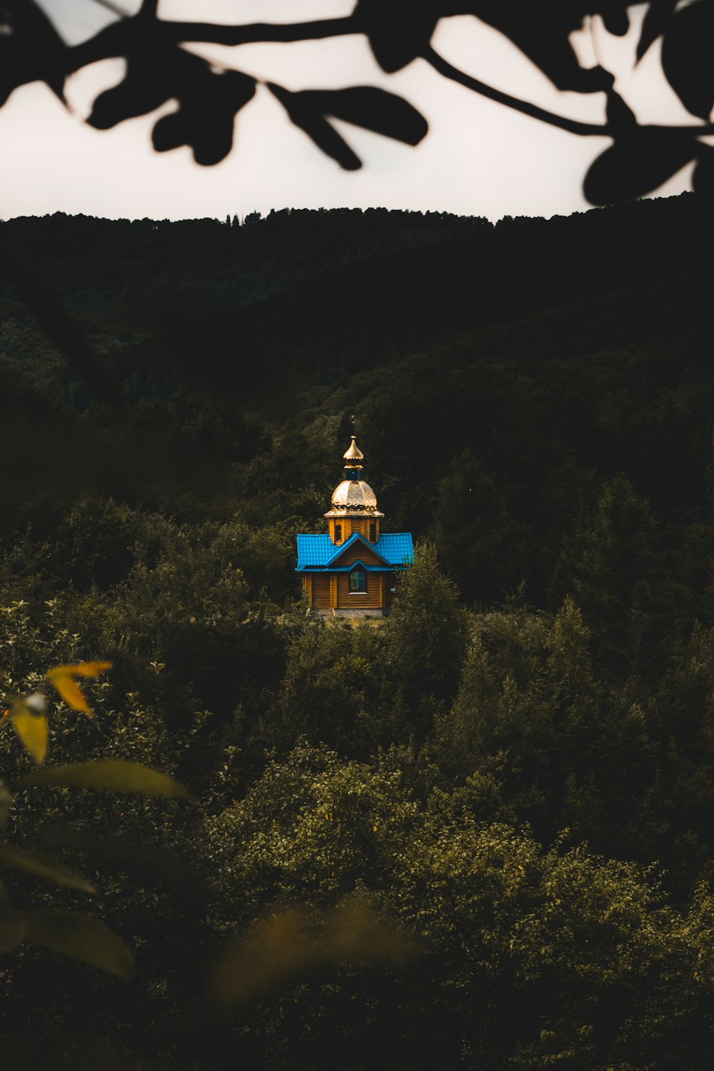 blue and white concrete building on top of mountain