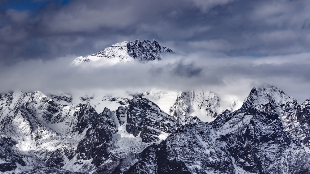 snow covered mountain under cloudy sky during daytime