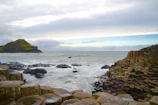 A sweeping drone shot of the Giant’s Causeway at sunset, highlighting the rugged coastline.