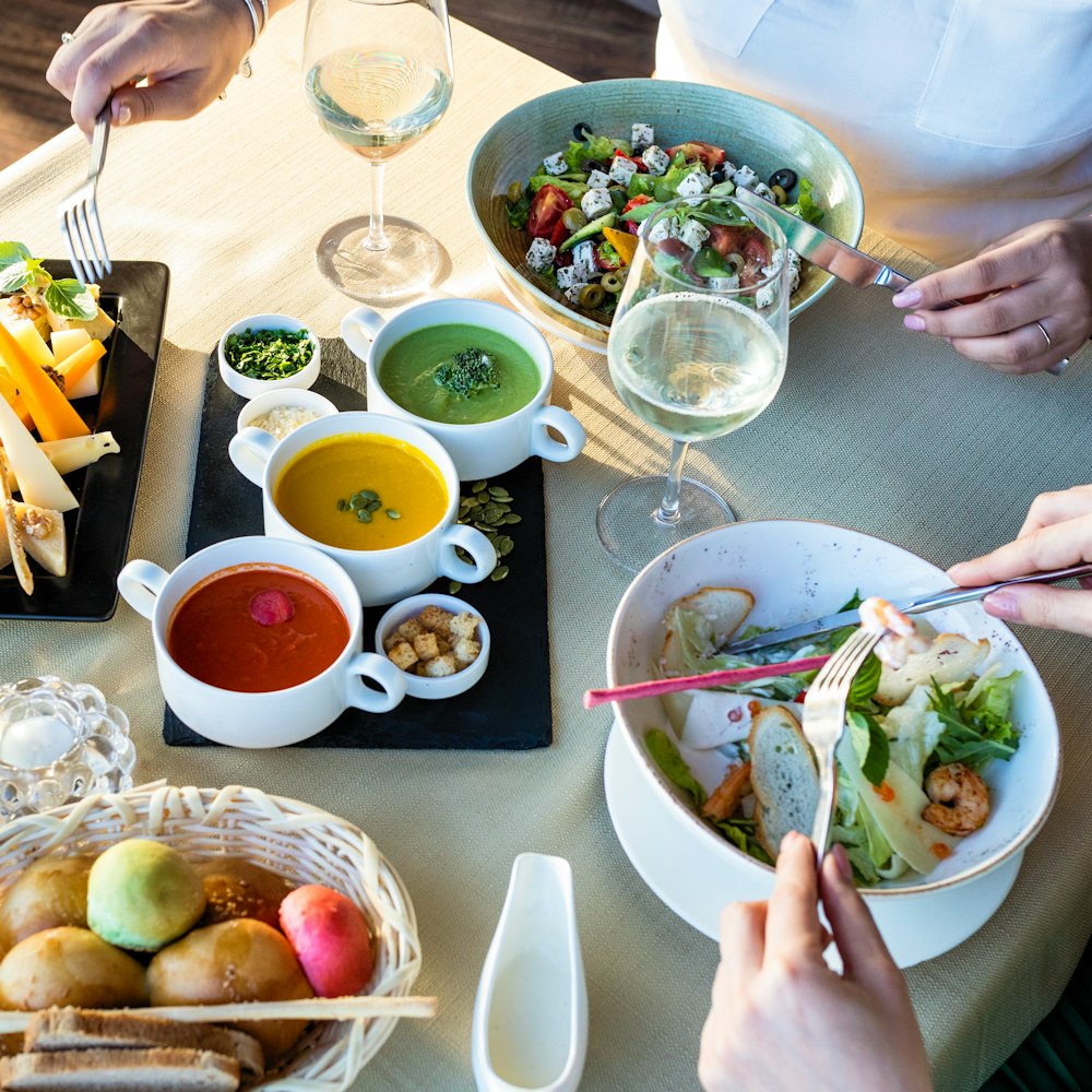 person holding chopsticks and bowl of vegetable salad