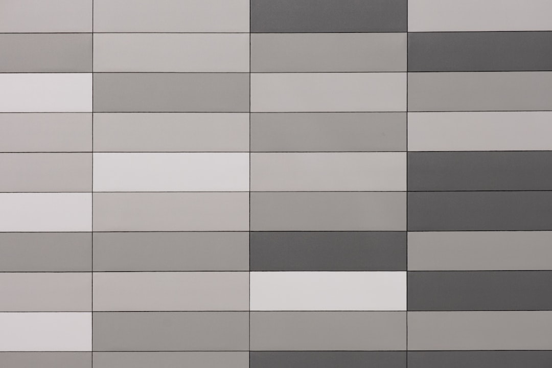 brown and black checkered textile, Grey and white wall.