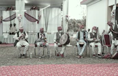 Musicians playing traditional Congolese rumba instruments in an open-air setting.