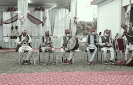 Musicians playing traditional Congolese rumba instruments in an open-air setting.