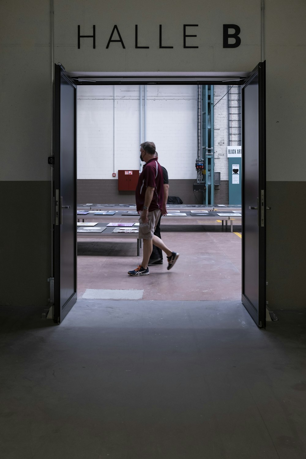 a man is walking out of a building