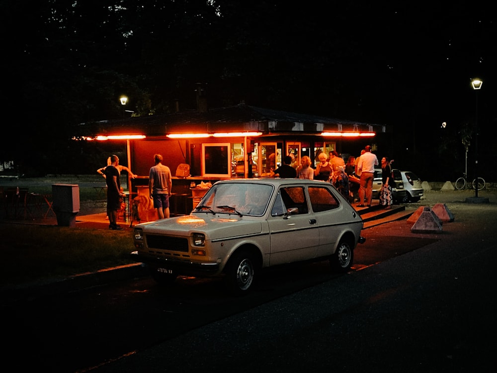 white suv parked on street during night time