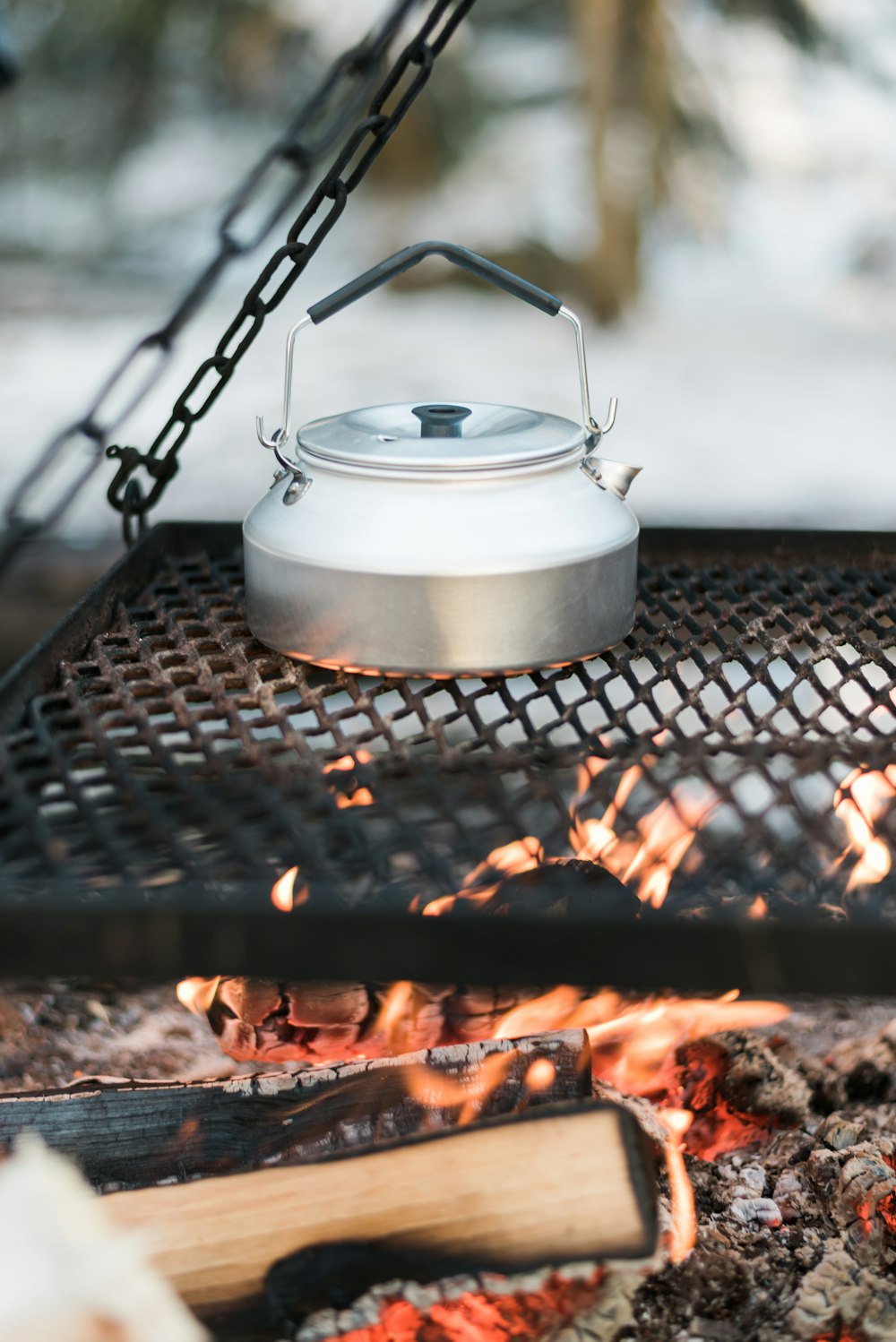 white ceramic pot on black metal grill