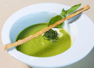 green soup in white ceramic bowl