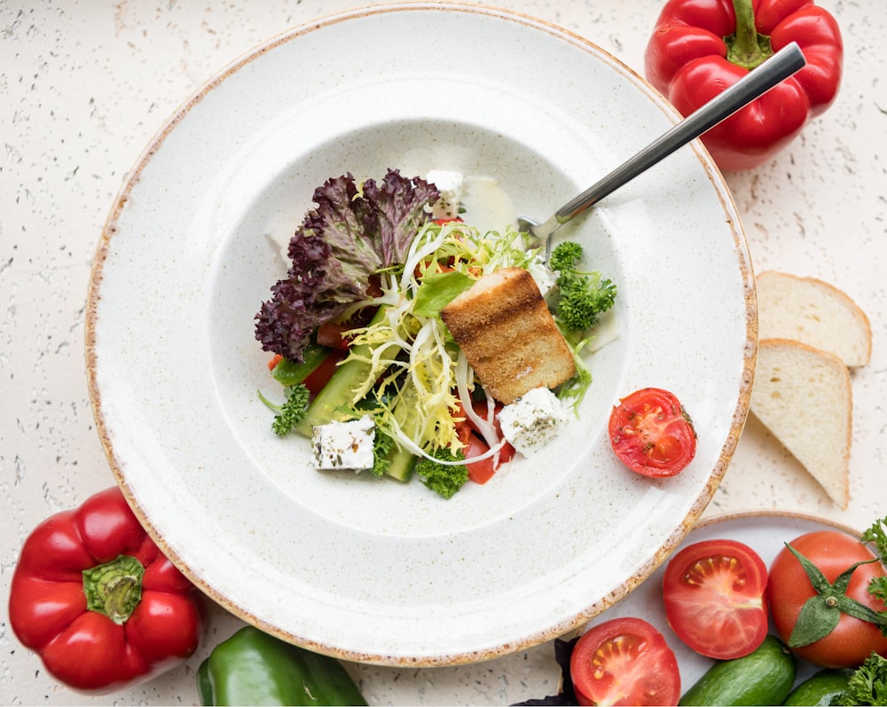 sliced tomato and green vegetable on white ceramic plate