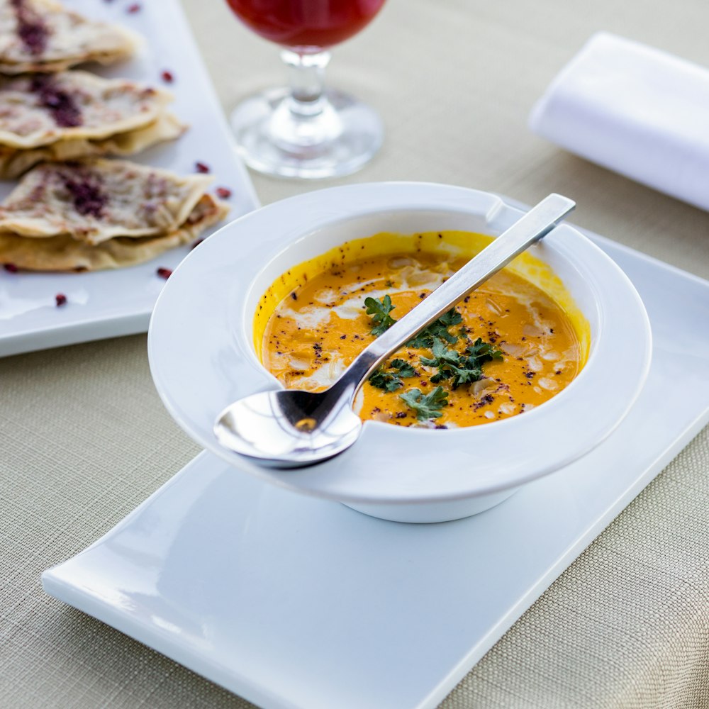 white ceramic plate with stainless steel spoon and fork