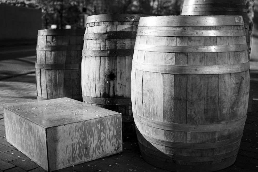 grayscale photo of wooden barrels