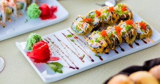 Colorful sushi rolls arranged artistically with fresh ginger and wasabi garnish