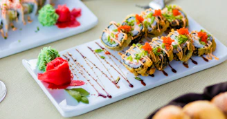An elegant wooden platter with sushi rolls garnished with bright fish roe and thin slices of radish.