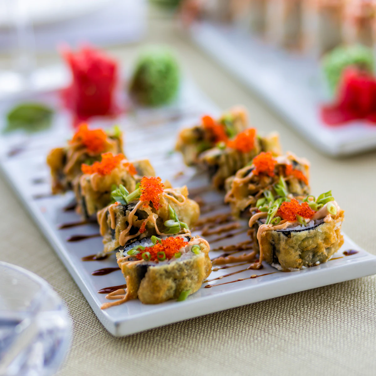 Sushi rolls with seafood arranged on a white plate