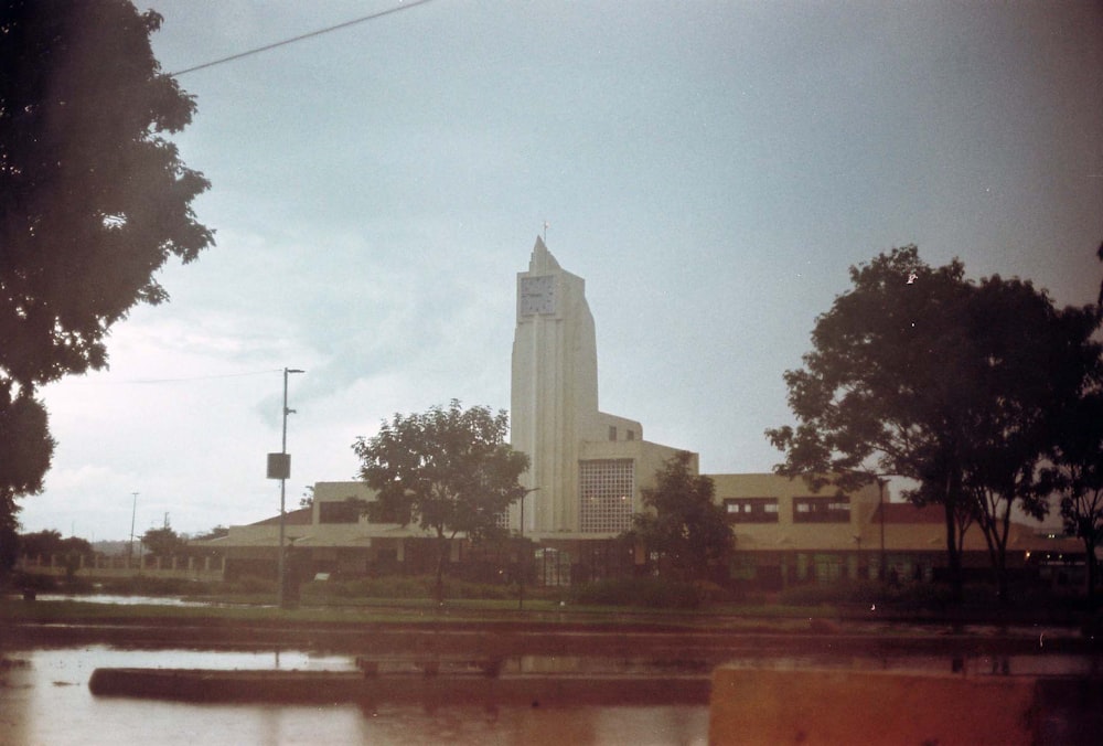 white concrete building near green trees during daytime