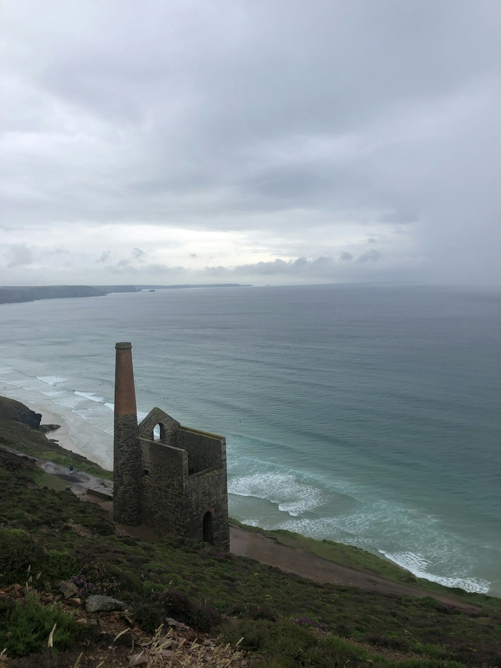 brown brick building near sea during daytime