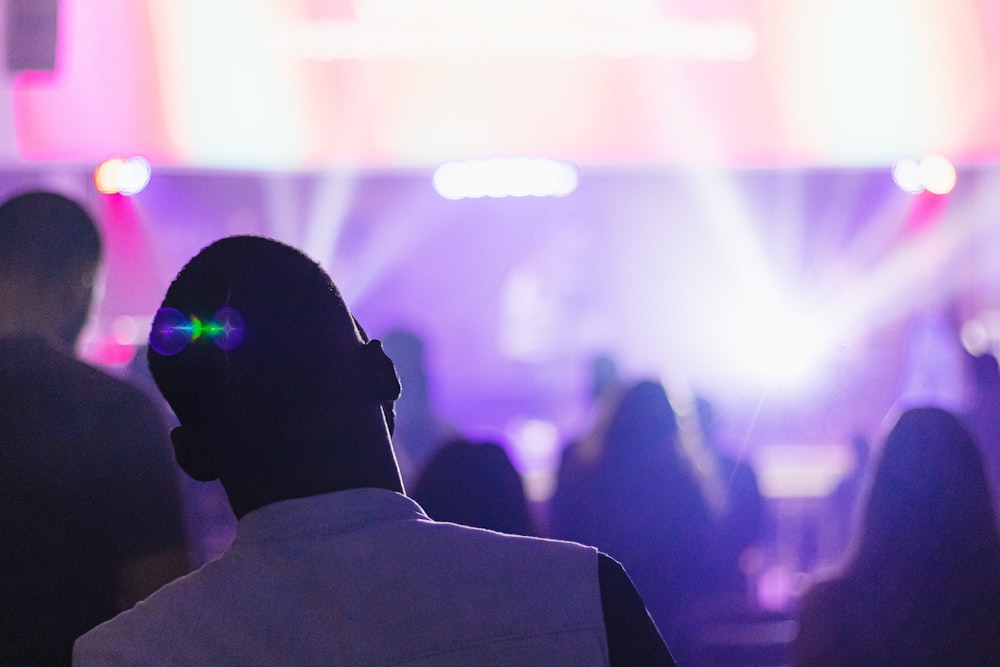 man in white shirt wearing black headphones