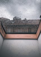 Close-up of a skylight before cleaning, showing hard-water stains and dirt buildup.