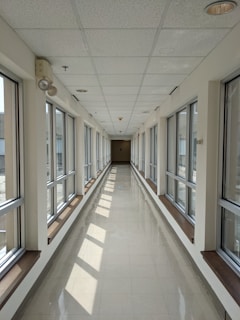 white and brown hallway with glass windows