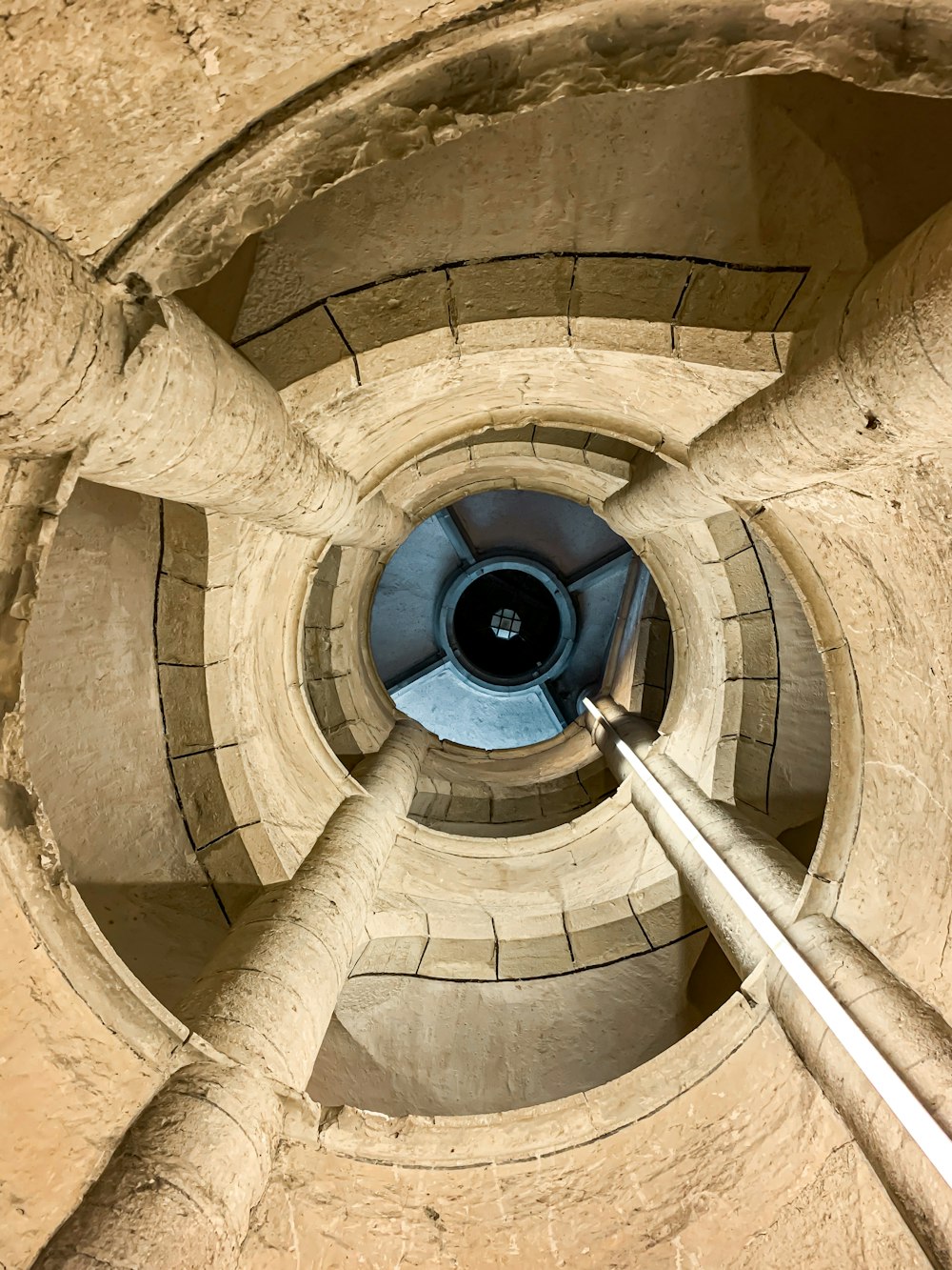 brown spiral staircase with blue round light