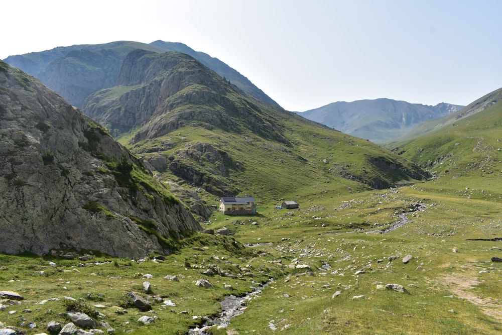 green grass field and mountains during daytime