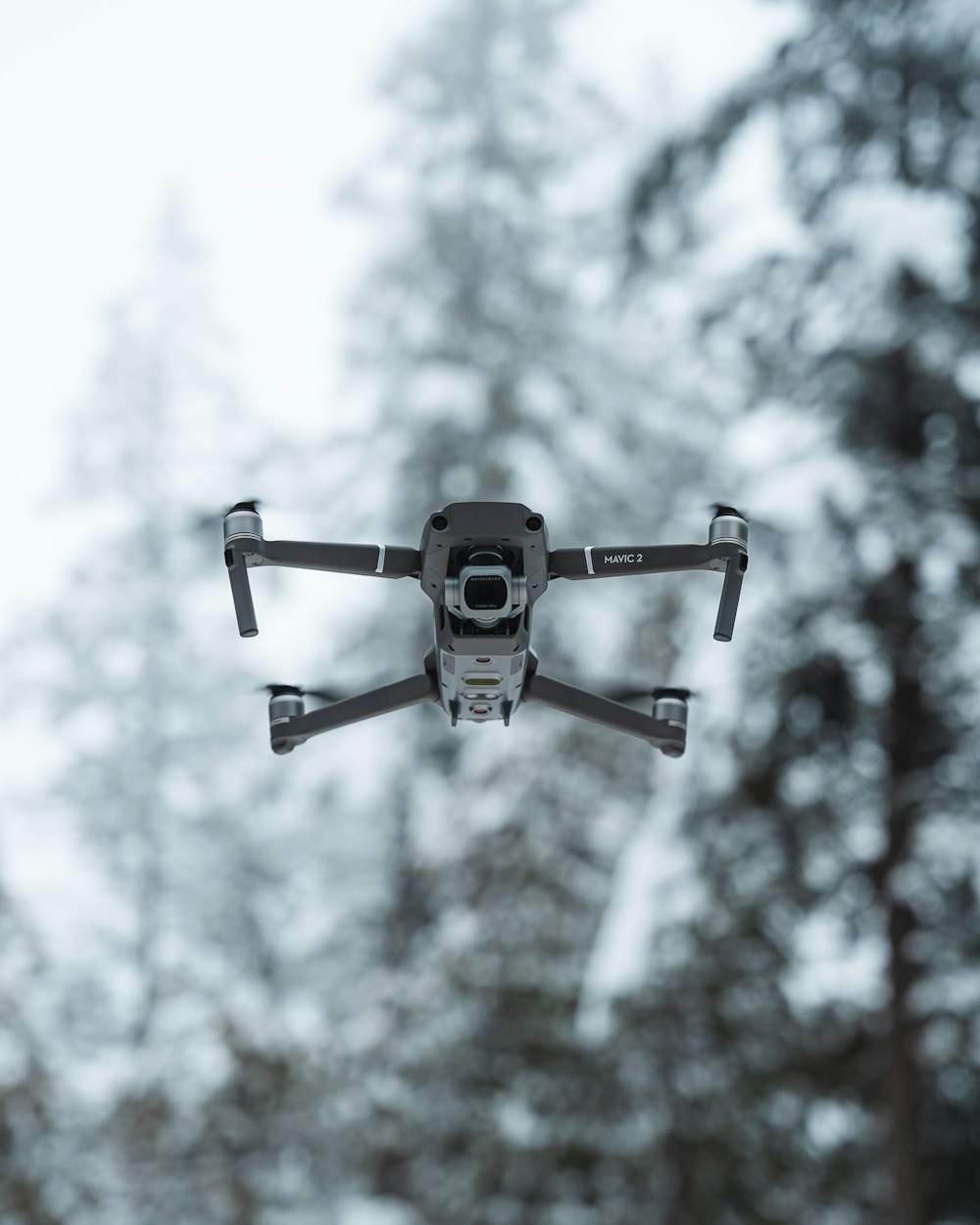 black and white drone flying in the sky