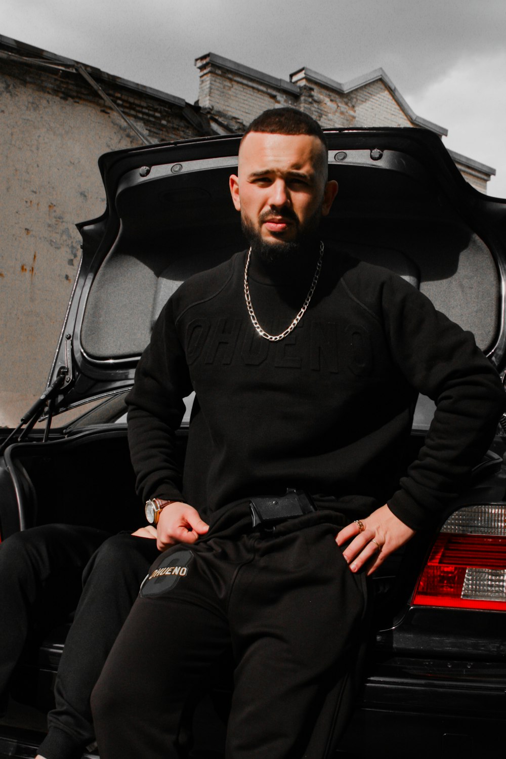 man in black long sleeve shirt sitting on black chair