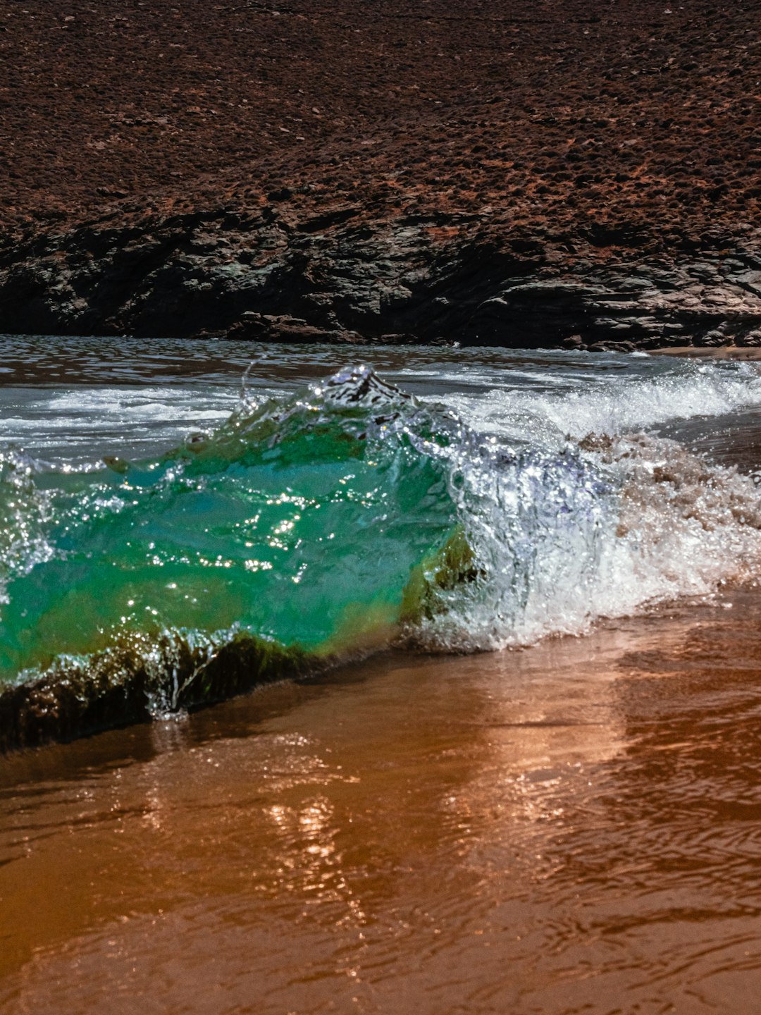 water waves on brown sand during daytime