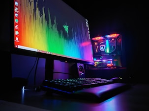 black flat screen computer monitor turned on beside black computer keyboard