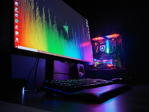 black flat screen computer monitor turned on beside black computer keyboard