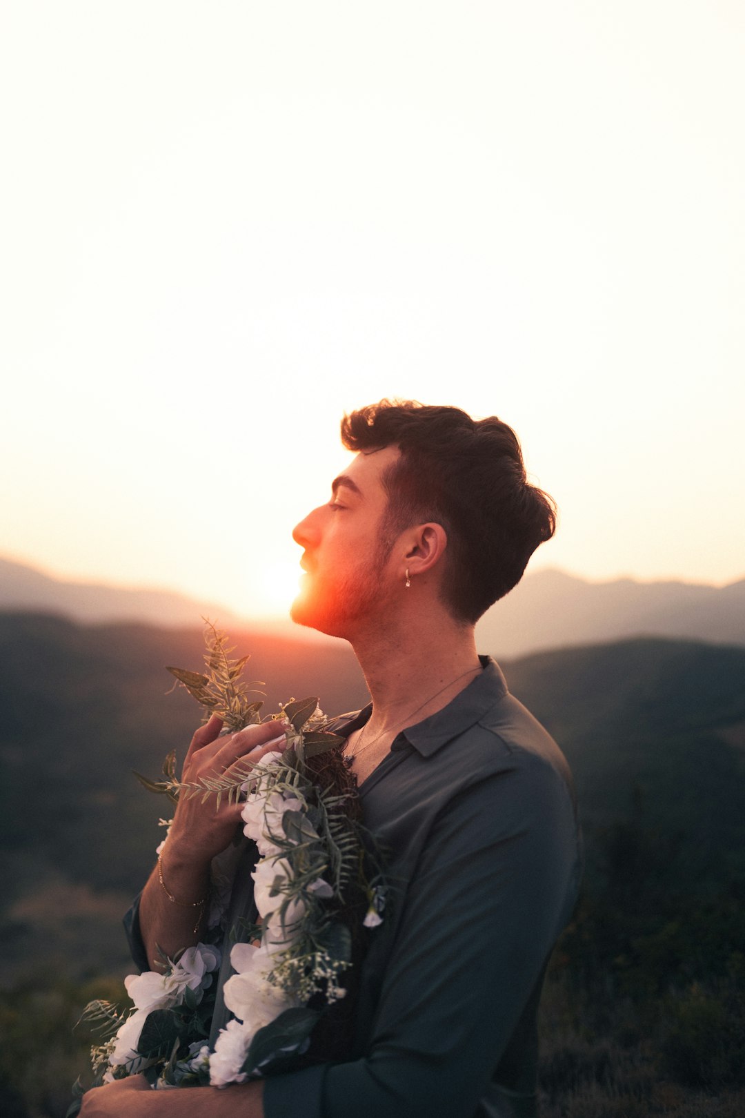 man in gray crew neck shirt standing during sunset