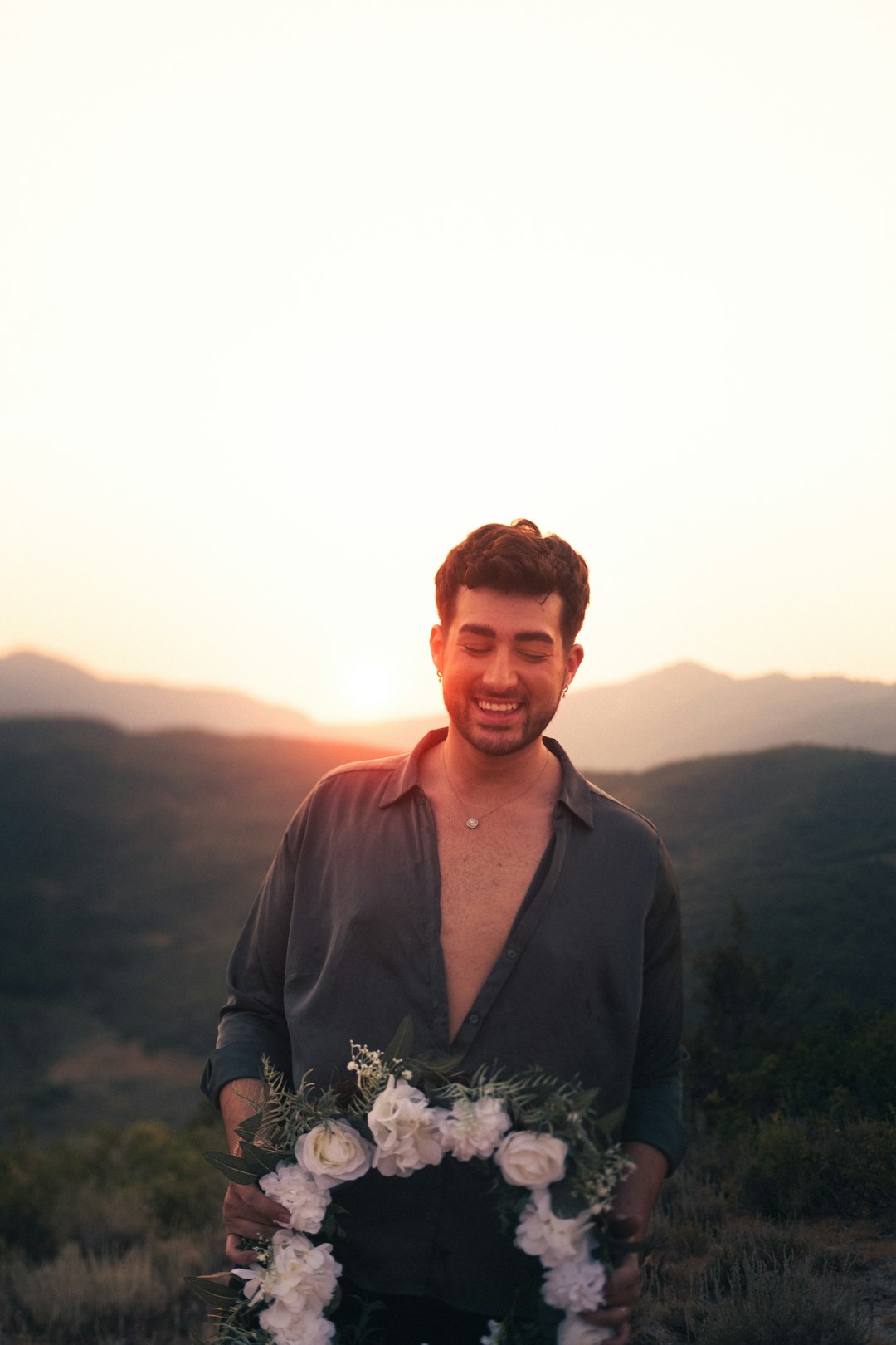 man in black leather jacket standing on mountain during daytime