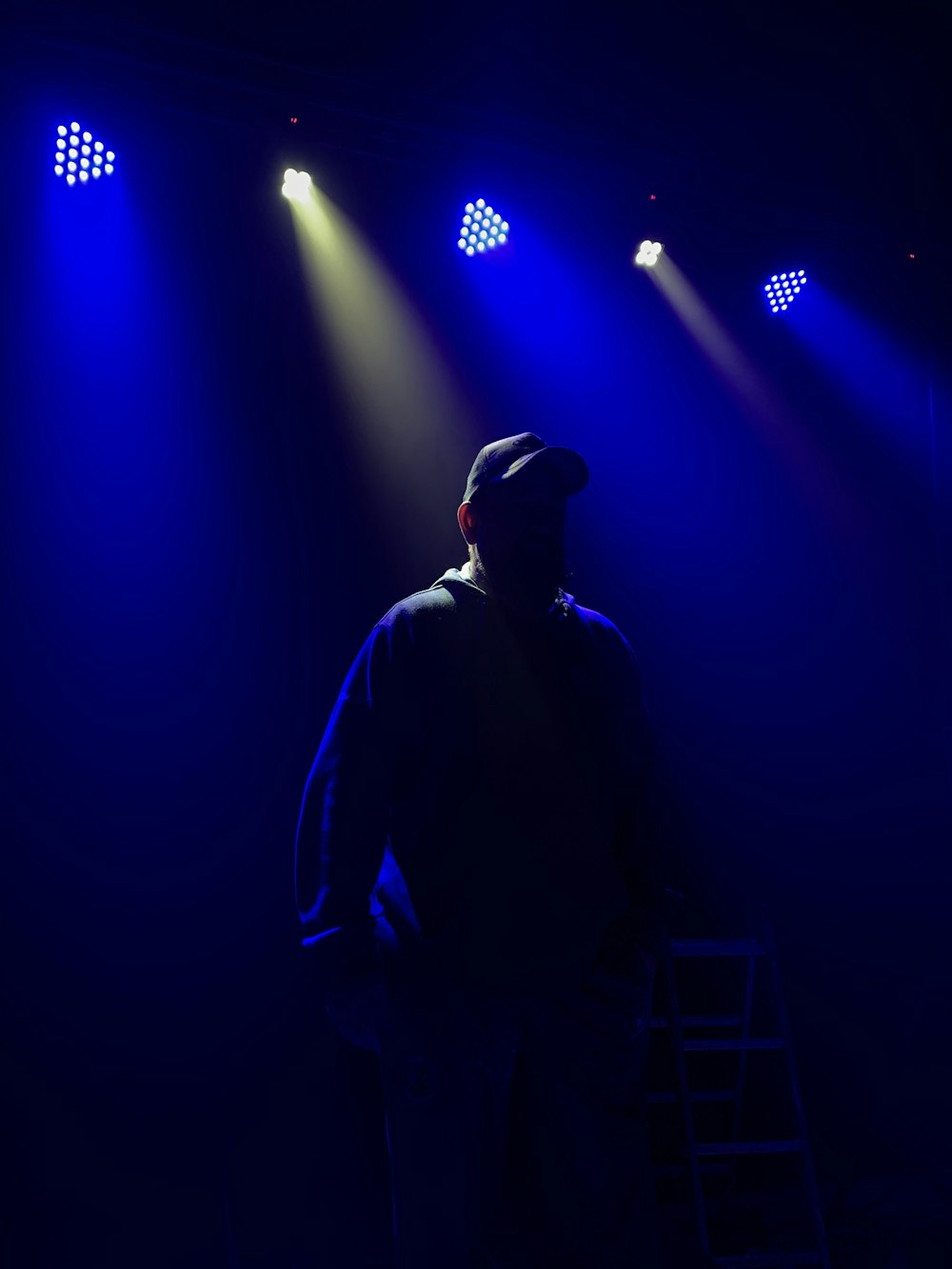 man in black jacket standing on stage