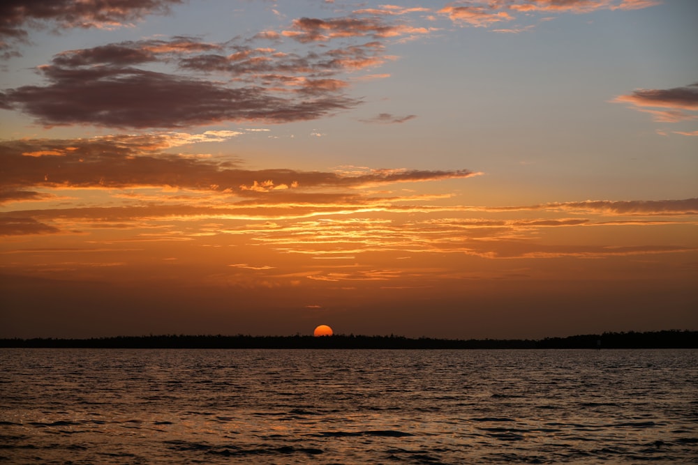 body of water during sunset