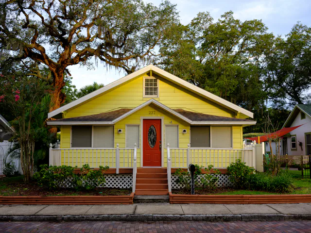 White and yellow wooden home representative of Clair-Mel FL