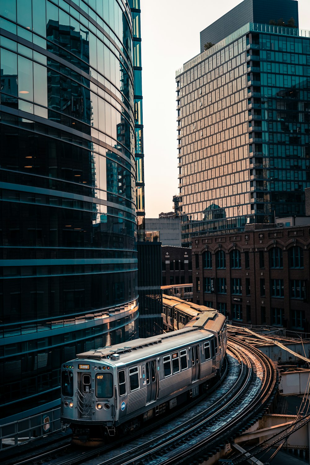 white bus on road near high rise buildings during daytime