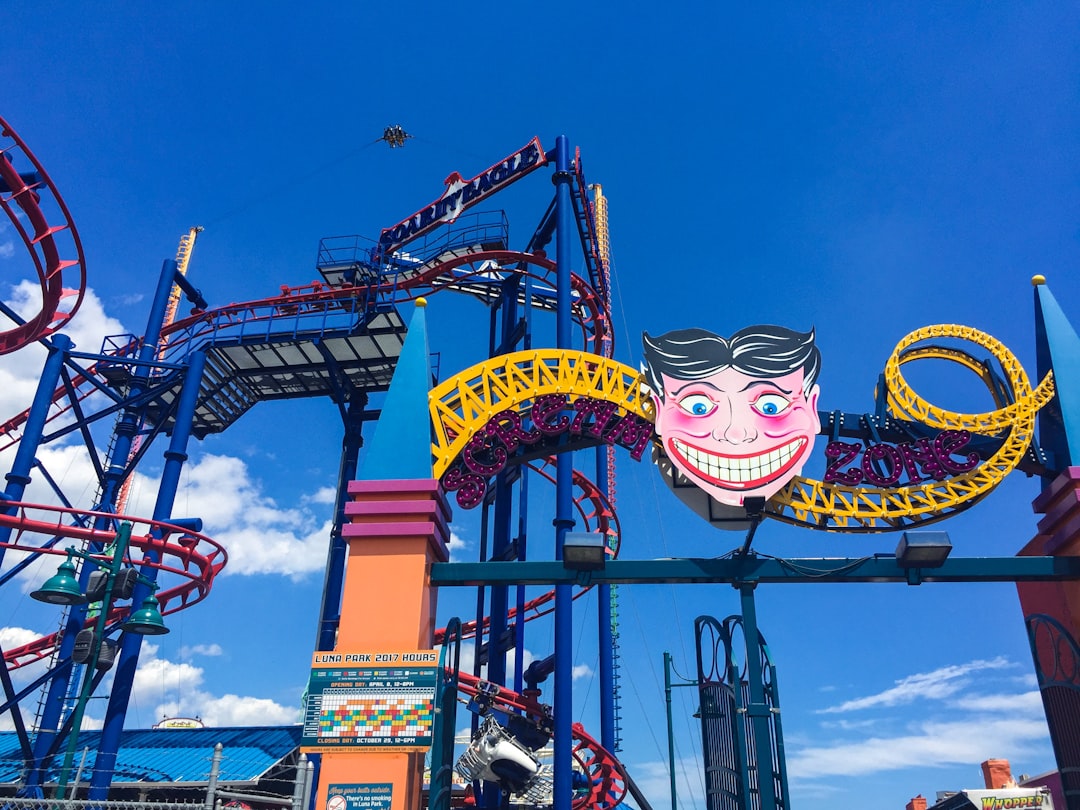 people riding roller coaster during daytime