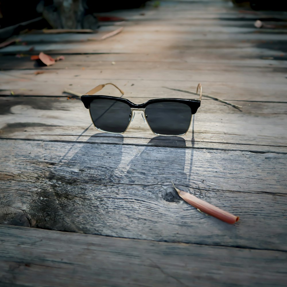black framed sunglasses on brown wooden table