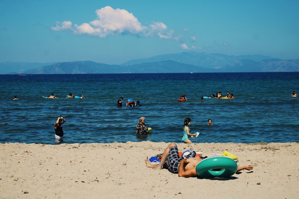 people swimming on sea during daytime