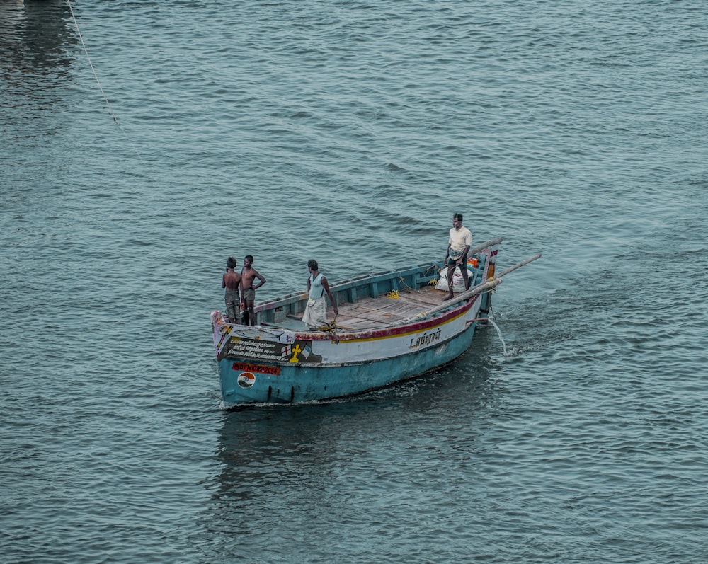 2 men and woman riding on boat on sea during daytime