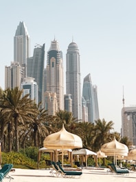 white and brown concrete building near green trees during daytime