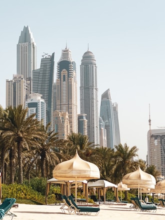 white and brown concrete building near green trees during daytime