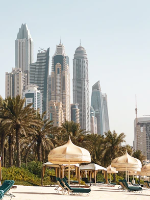 white and brown concrete building near green trees during daytime