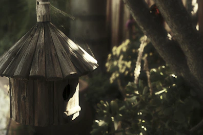 Rustic wooden birdhouses and garden decor displayed on a sunny porch.