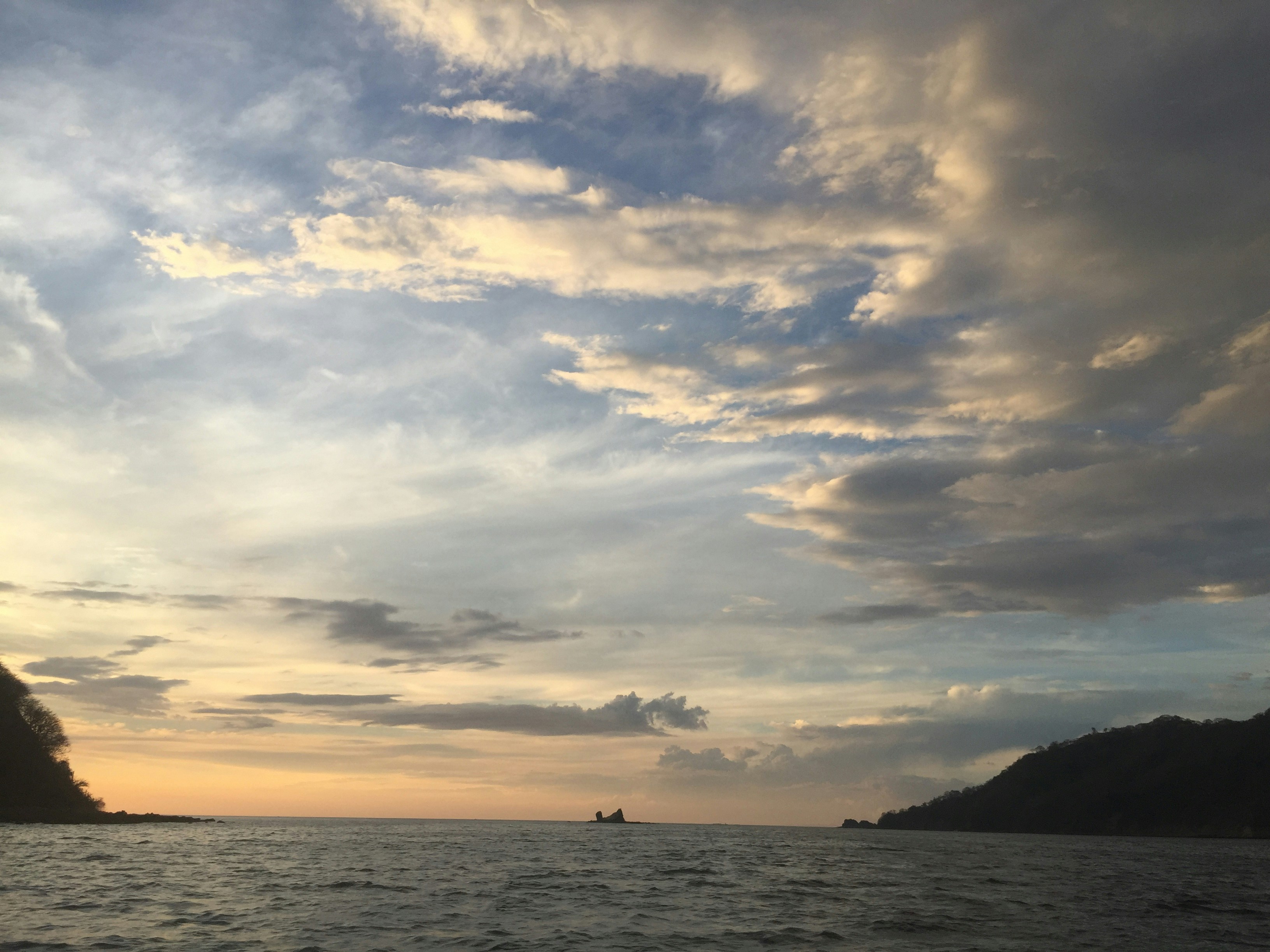 Dramatic ocean landscape with tropical islands and deep blue waters at sunset