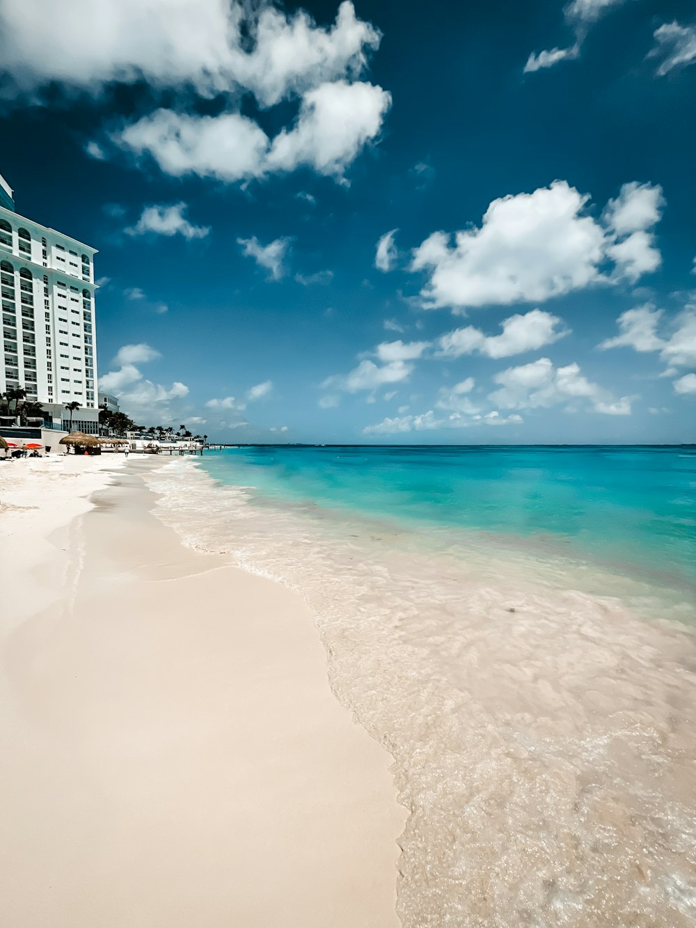 white and blue sky over beach