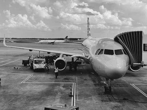 grayscale photo of airplane on airport