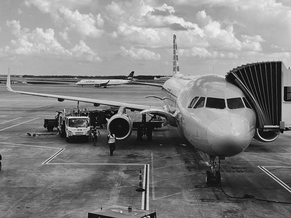 grayscale photo of airplane on airport